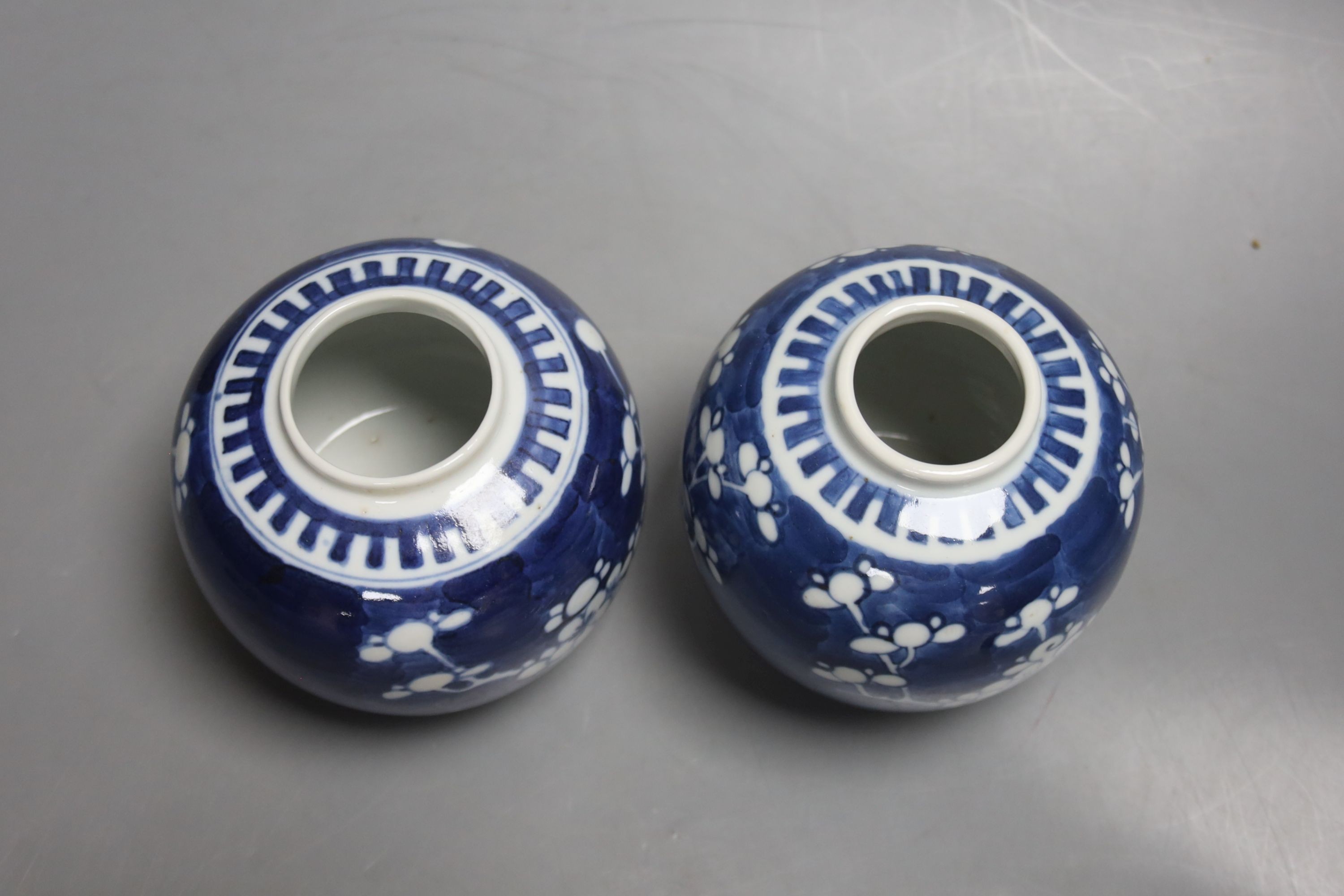 A pair of early 20th century blue and white prunus jars and covers